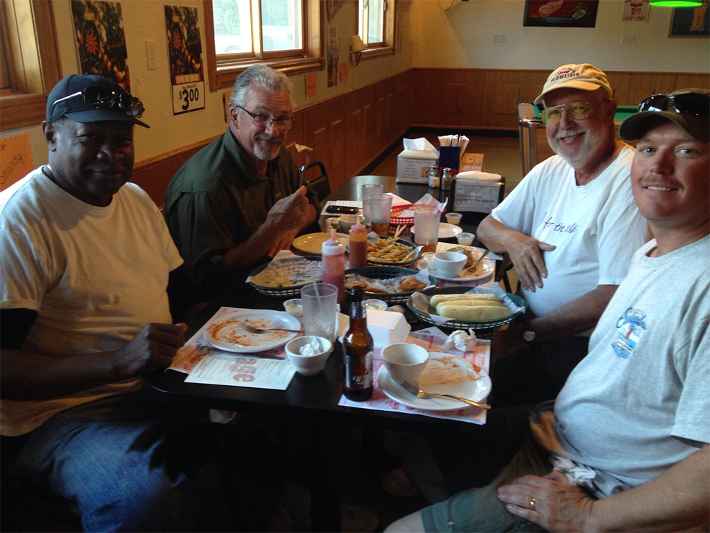 Another captain and his fellow fishermen enjoying their catches, cooked by us, after their fishing charter.